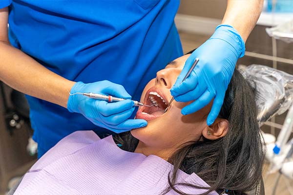 Dr. Lee working on a woman's teeth for dental inlay.