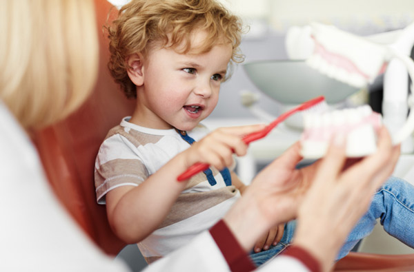 Little boy learning to brush teeth at Picasso Dental Care in Temecula, CA